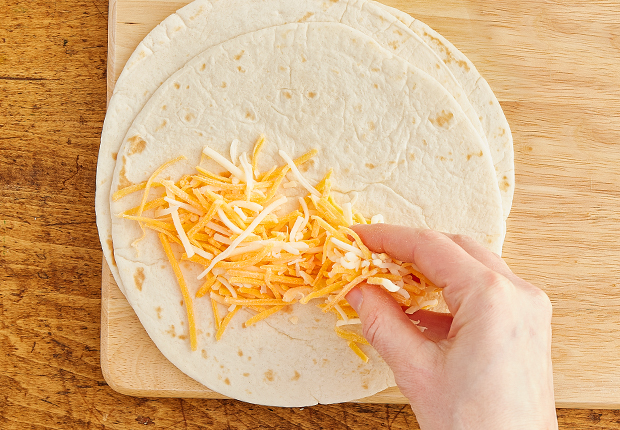 Shredded cheese on a tortilla