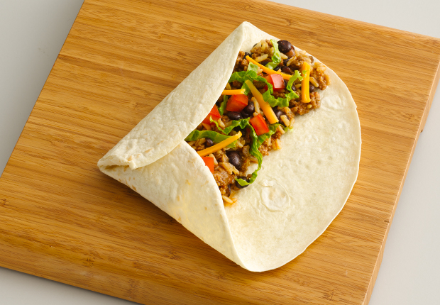Left third of the tortilla folded over the ingredients with the bottom third of the tortilla folded up